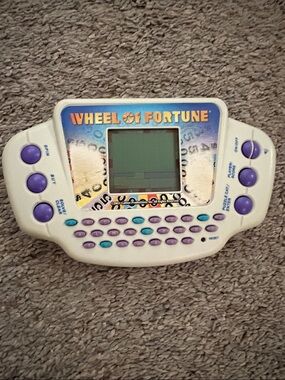 Hasbro Wheel of Fortune Handheld Game - White with Purple & Teal Buttons